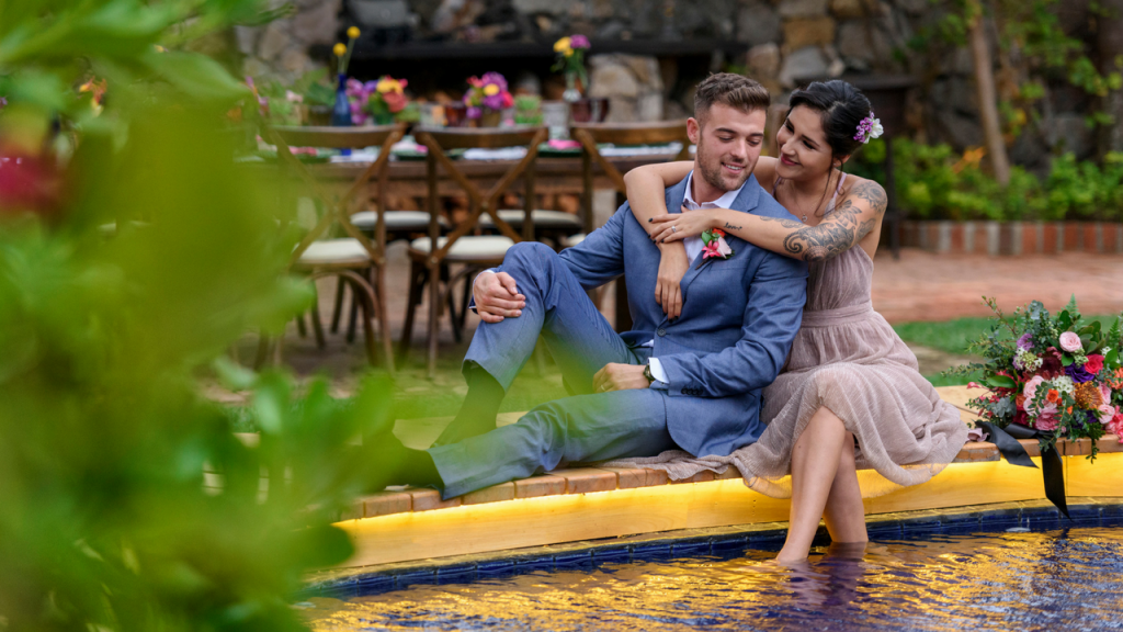 Happy couple at their pool view garden Wedding Reception